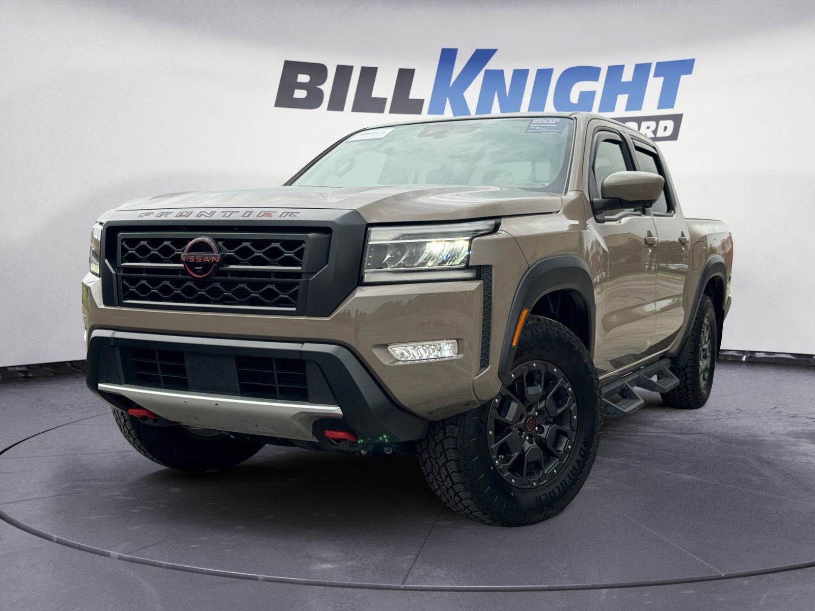 2023 Nissan Frontier PRO-4X in Baja Storm — front three-quarter view